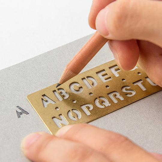 Made from solid brass with a tactile weight and finish, this piece works as both a bookmark and an alphabet template you can slot into your notebook or planner.