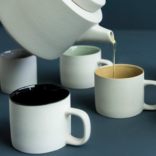 Lifestyle image of large stoneware teapot from Dutch company Kinta who produce contemporary ceramics and homeware. The large teapot is clay grey in colour, with a soft matt exterior finish.
