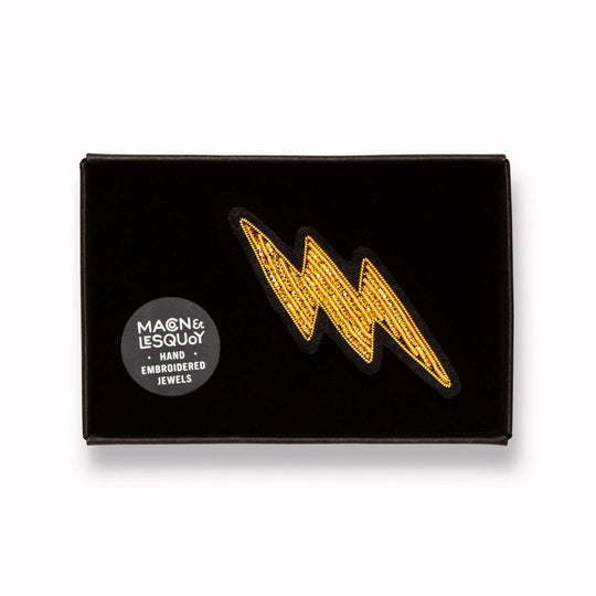 Make a statement with this beautiful gold lightning bolt hand embroidered decorative lapel pin by Paris based Macon et Lesquoy