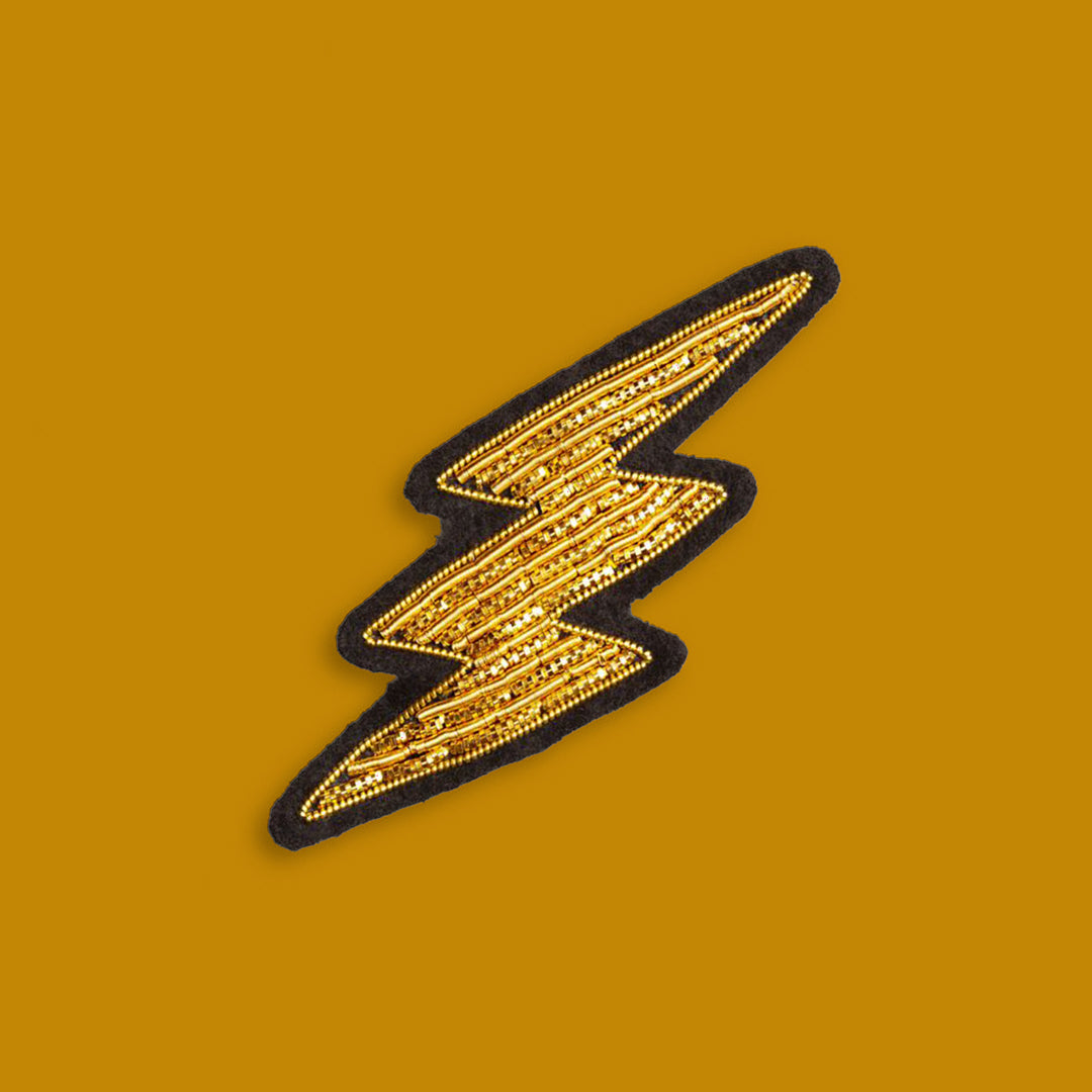 Make a statement with this beautiful gold lightning bolt hand embroidered decorative lapel pin by Paris based Macon et Lesquoy