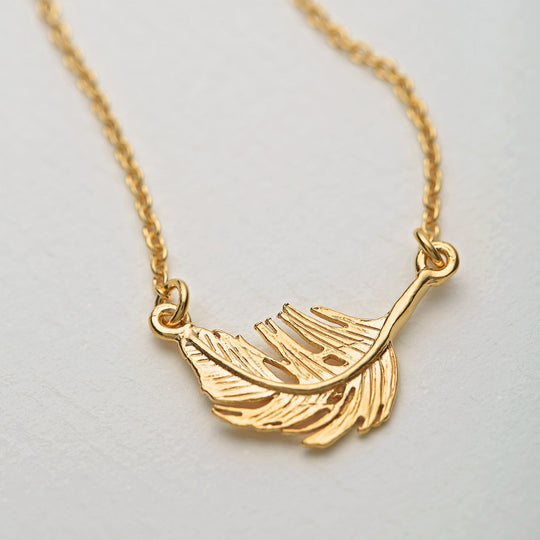 A delicately detailed floating gold feather in-line necklace from Alex Monroe's Classics jewellery collection.