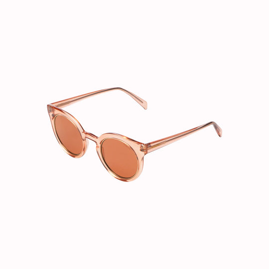 Sideways View of the Lulu, featuring a unique combination of round lenses set in a cat-eye frame and offers unparalleled style and protection with a 133mm x 49.4mm Bio Nylon frame, 100% UV400 lenses, and scratch-resistant PC lens. The gorgeous sunglasses feature a translucent rose coloured frame with solid light burgundy lenses. The perfect rose-tinted glasses!