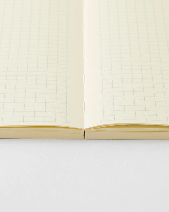 A5 grid paper notebook with a simple and clean off white cover and embossed MD Paper logo.