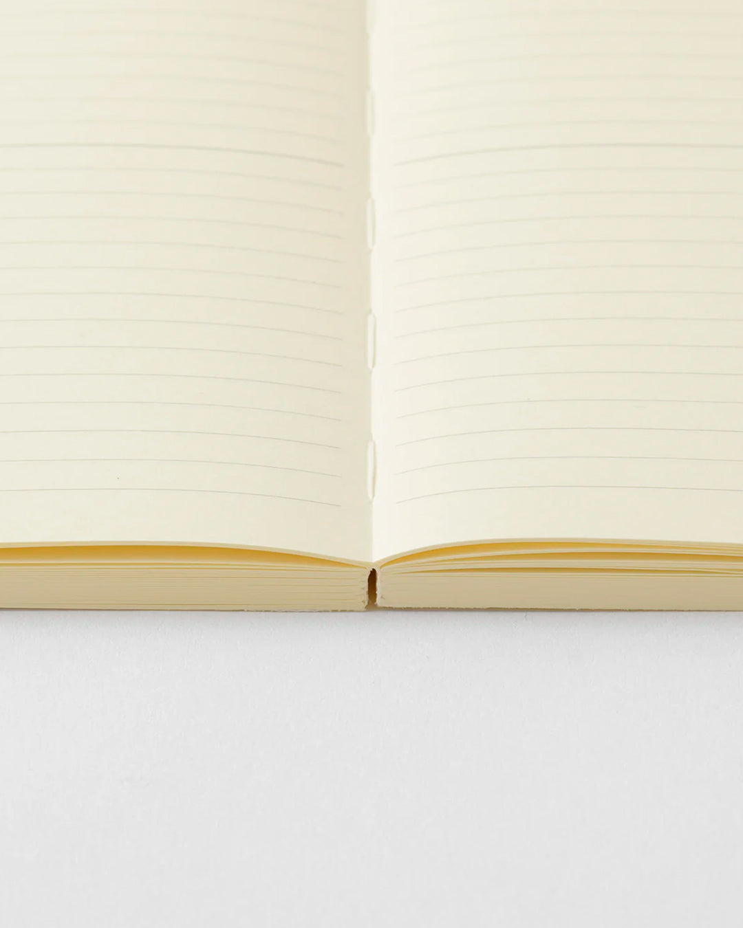 A5 ruled paper notebook with a simple and clean off white cover and embossed MD Paper logo.