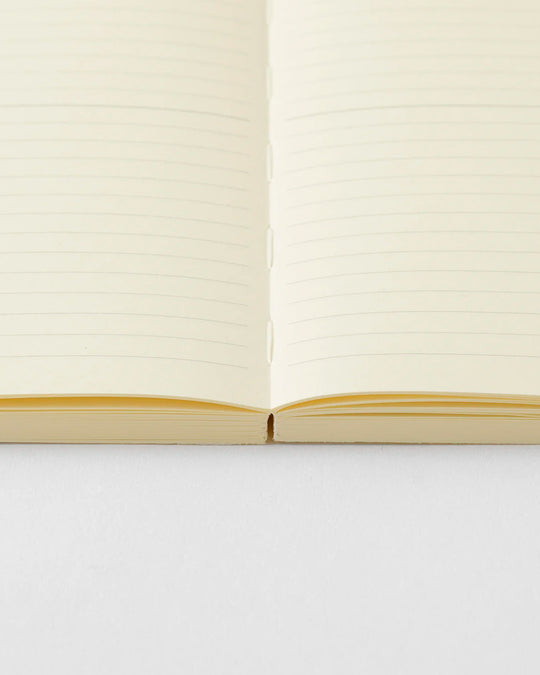 A5 ruled paper notebook with a simple and clean off white cover and embossed MD Paper logo.