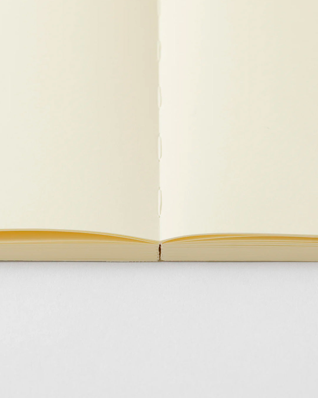 A5 plain paper notebook with a simple and clean off white cover and embossed MD Paper logo.