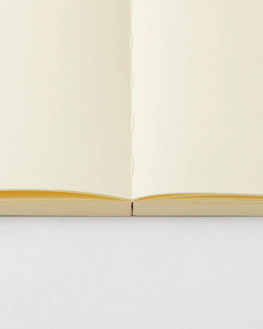 A5 plain paper notebook with a simple and clean off white cover and embossed MD Paper logo.