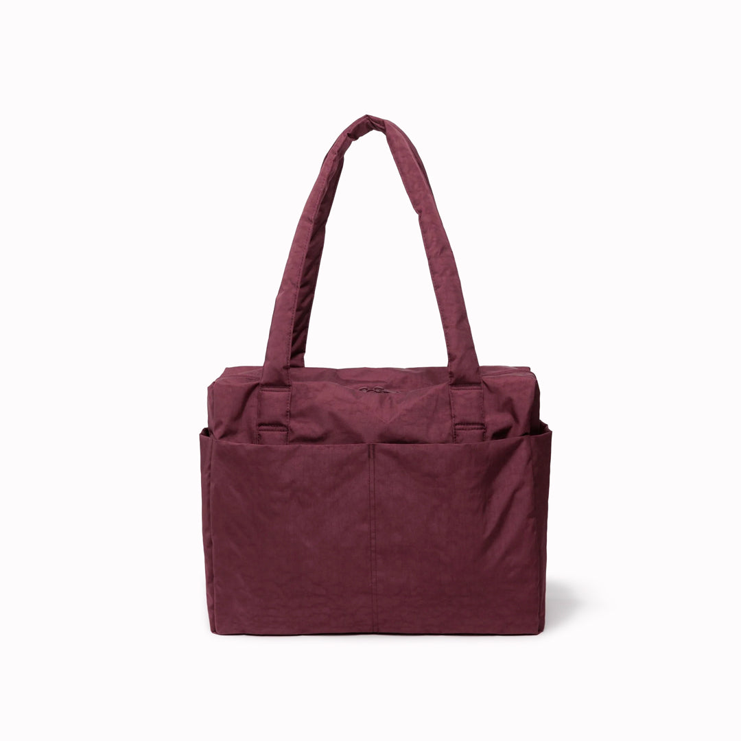 The small 'Cloud' Carry-On from Baggu is constructed from durable heavyweight nylon. Its versatile design has been optimised for air travel where its size allows it to fit under an aeroplane seat.