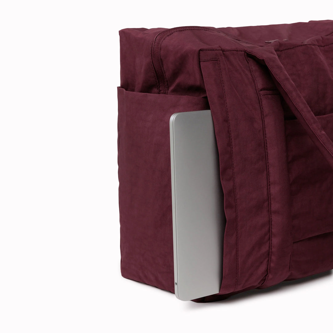 The small 'Cloud' Carry-On from Baggu is constructed from durable heavyweight nylon. Its versatile design has been optimised for air travel where its size allows it to fit under an aeroplane seat.