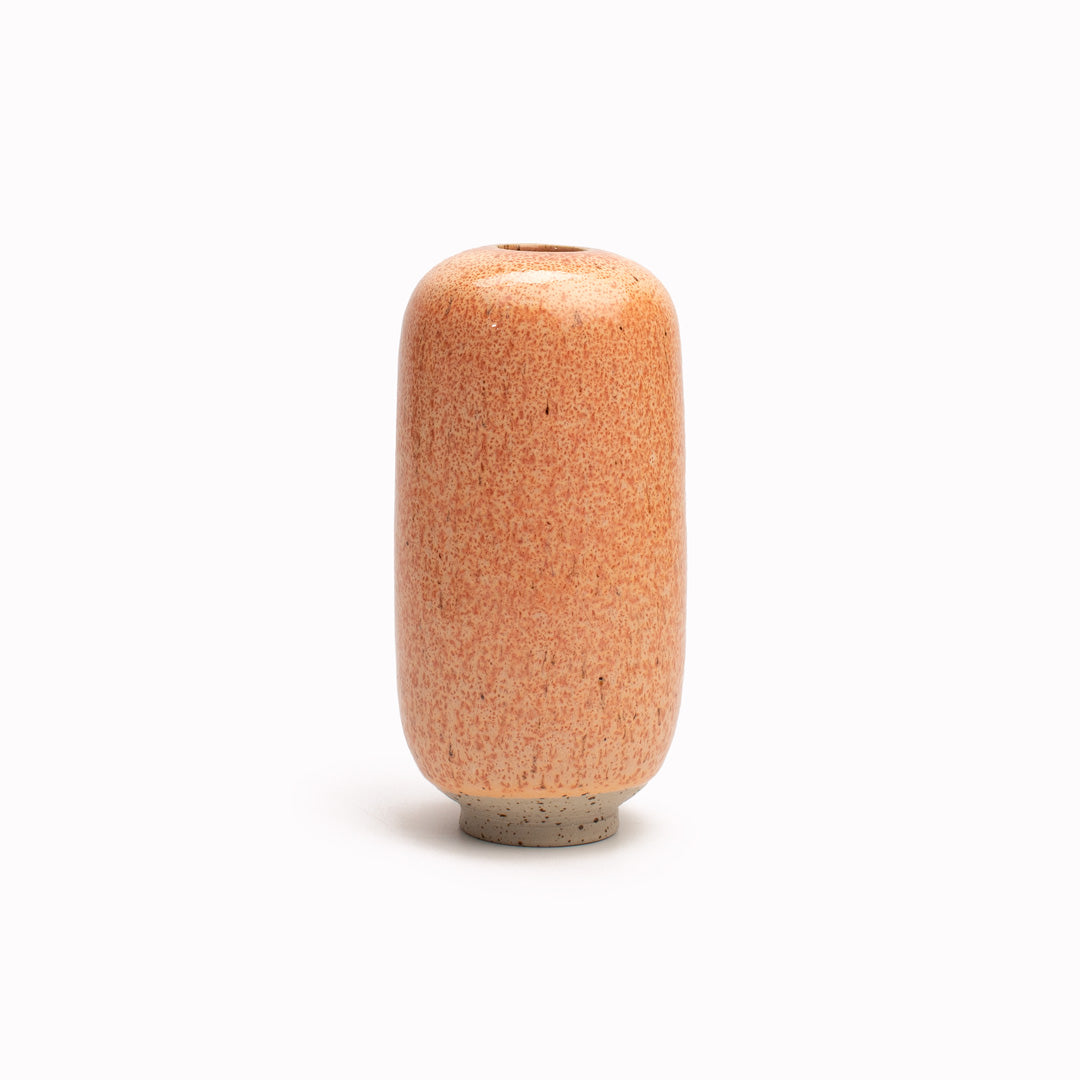 Orange Mamey Sapote design is hand-thrown in watertight stoneware. Due to the rounded taper at the top of the vase, the glaze melts down the sides of the cylindrical vase mimicking melting ice.