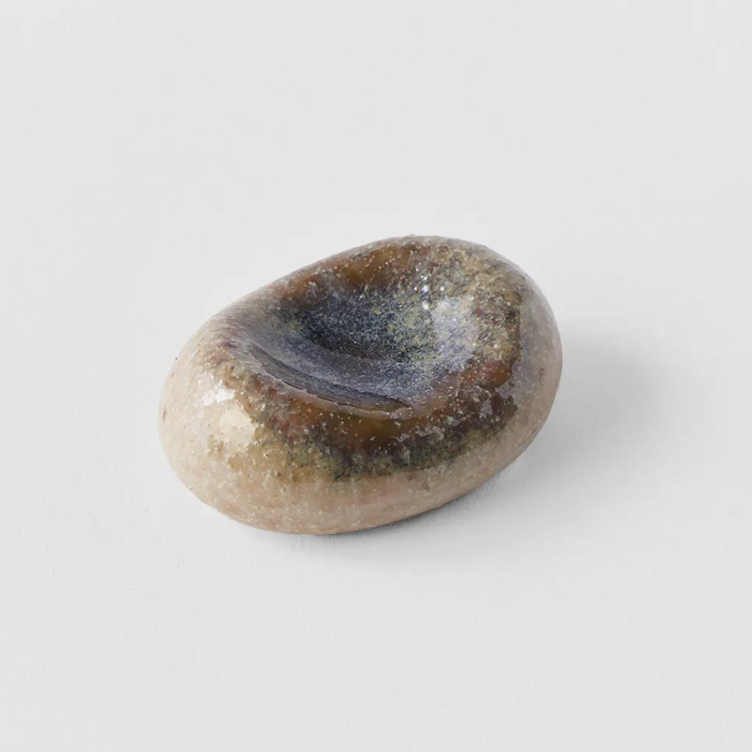 This brown/natural marbled ceramic pebble makes a perfect chopstick rest, inspired by the organic shape of river pebbles and has a mottled glaze.