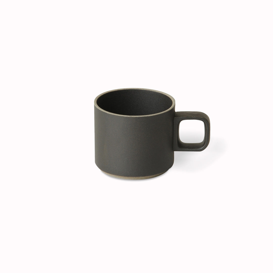 The small matt black mug by Hasami Porcelain is a low stackable mug for hot drinks such as green tea or coffee.