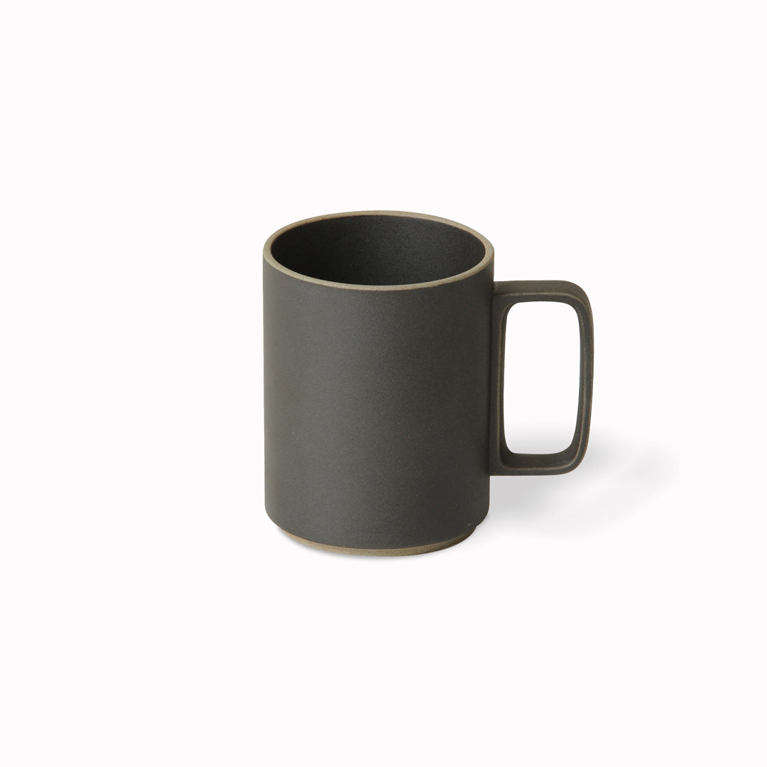 The large matt black mug by Hasami Porcelain is a tall stackable mug for hot drinks such as tea or coffee.