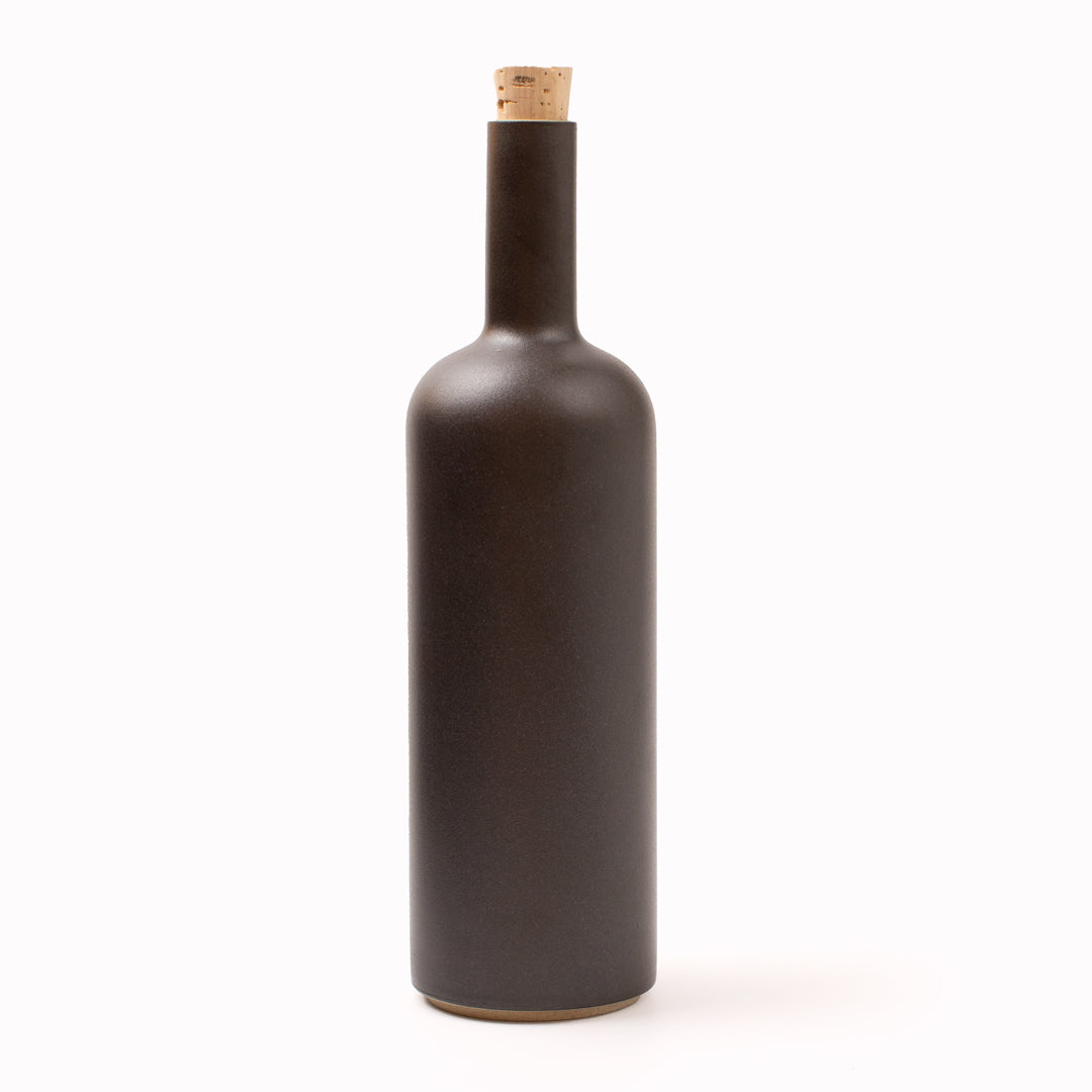 The matt black serving bottle by Hasami Porcelain is a modern Japanese minimal design beautiful porcelain bottle with cork stopper, suitable for use as a serving bottle for water at the dinner table, or for drizzling oil, or simply as a beautiful object in its own right.