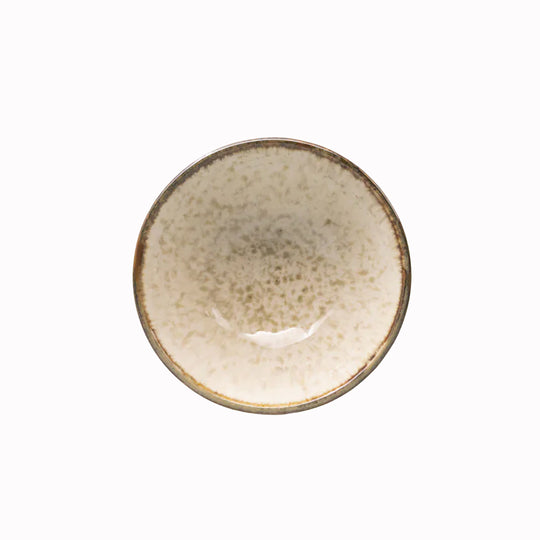 A handcrafted ceramic bowl with a gently flared profile, featuring a creamy glaze with warm, toasted rim accents.