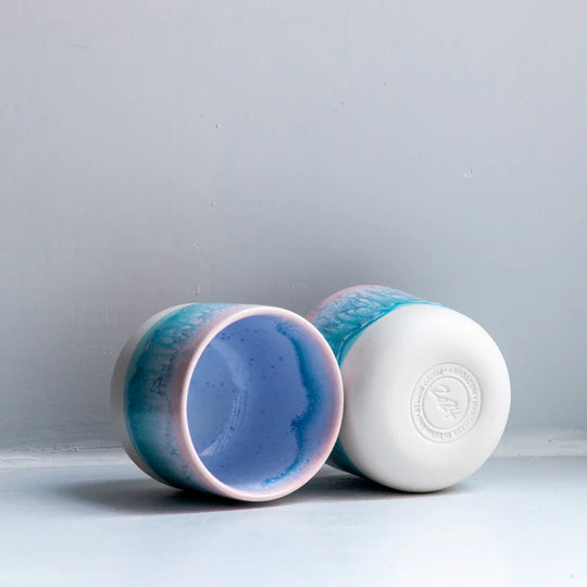 The pale blue over pink glaze Miami Sip Cup - Danish/Japanese mix up with this thick glazed, hand made ceramic small beaker from Studio Arhoj's Tokyo Series.