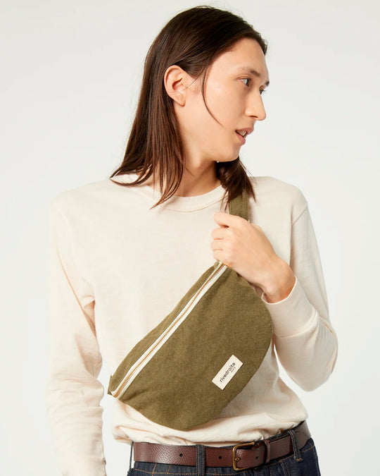 The Military Green Custine Belt Bag is a stylish and practical accessory crafted from upcycled denim. Designed by Rive Droite, a brand known for its commitment to sustainable fashion