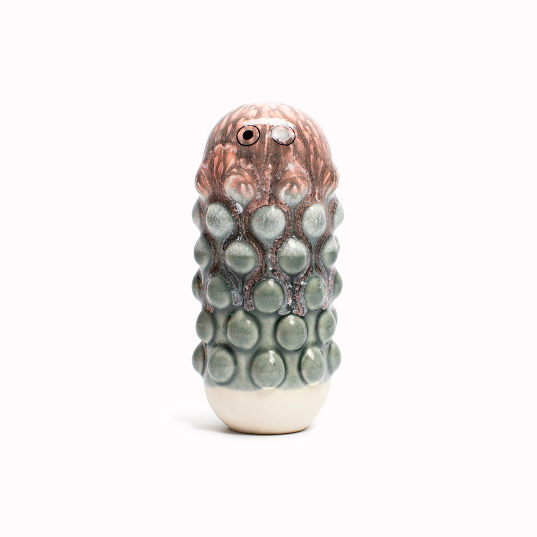 Pink Grey Mimi, a barnacle encrusted, bobbly, hand glazed ceramic figurine created as a close relative of the classic Arhoj Ghost.