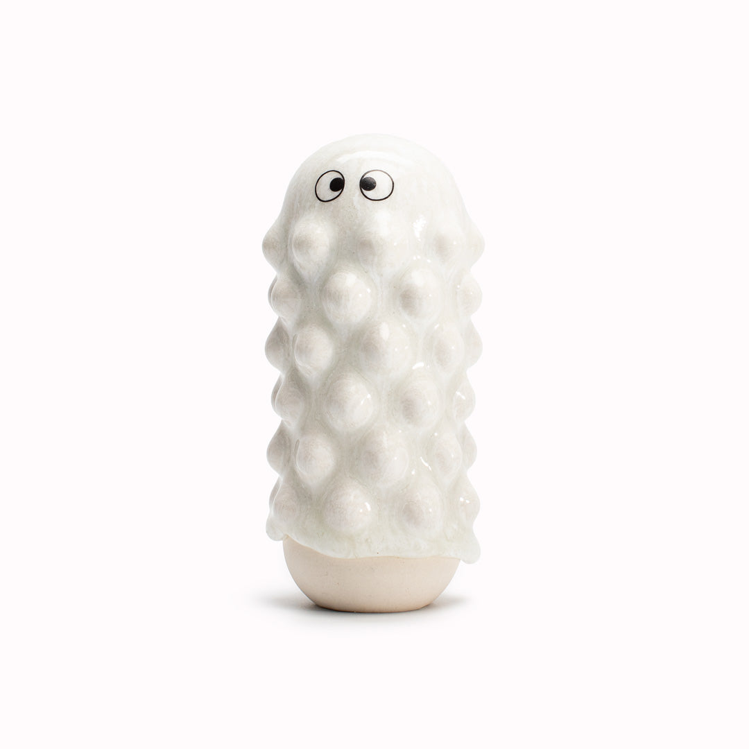 White Mimi, a barnacle encrusted, bobbly, hand glazed ceramic figurine created as a close relative of the classic Arhoj Ghost.