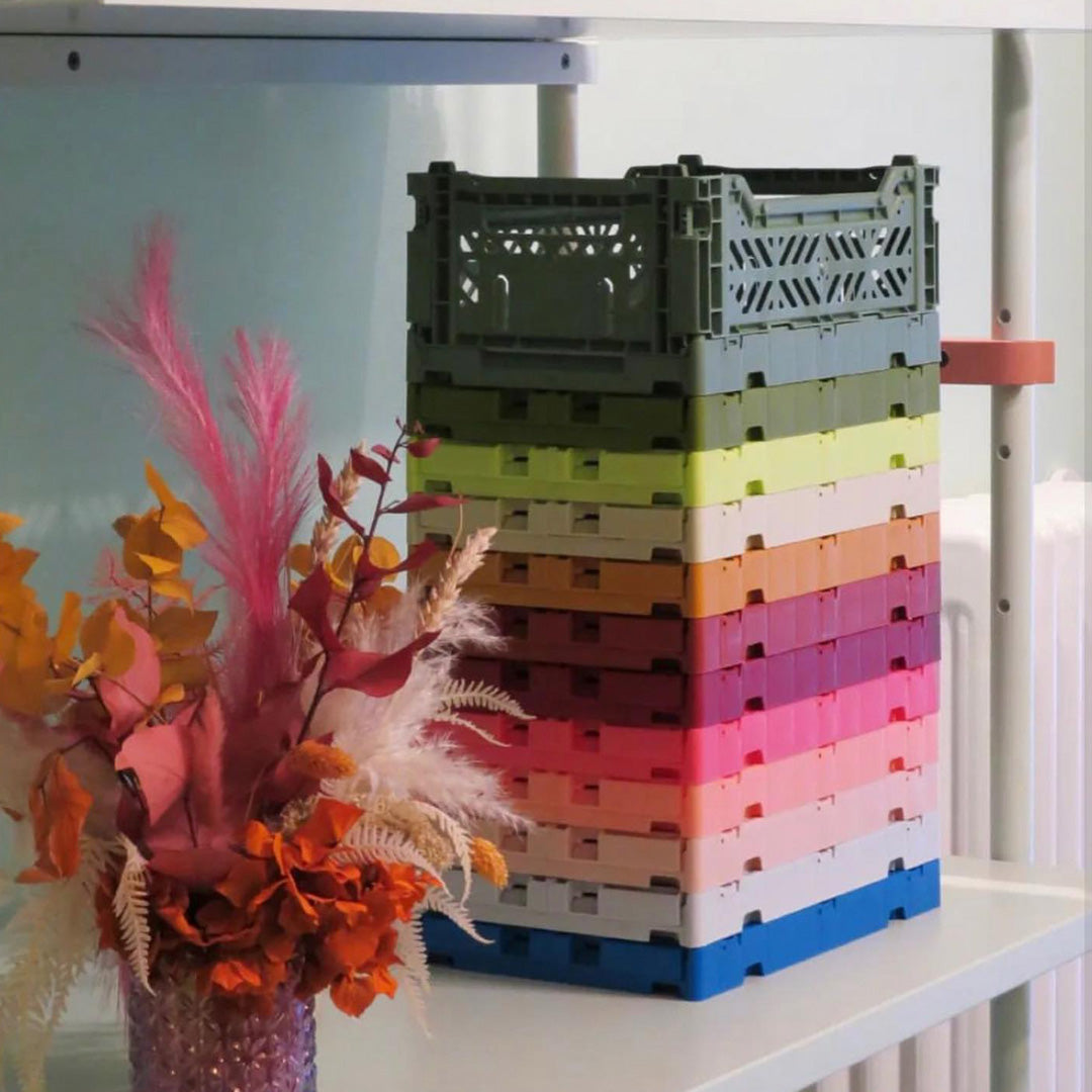 Colourful stack of Folding Crate from Aykasa. This crate is made from 100% recyclable material and can be folded flat when not in use. It's perfect for holding books, toys, clothes, or anything else you want to organise. 