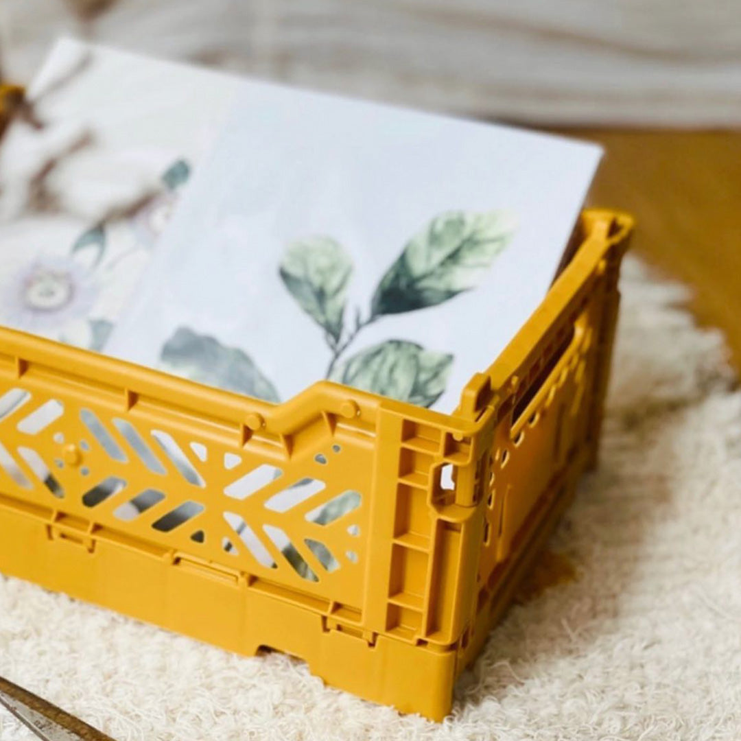 Detail of Folding Crate from Aykasa. This crate is made from 100% recyclable material and can be folded flat when not in use. It's perfect for holding books, toys, clothes, or anything else you want to organise. 