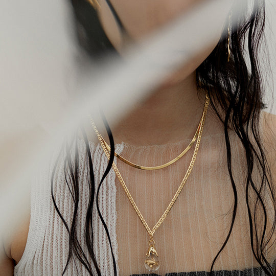 Mio Chain in Gold. Its sinuous, snake-like chain design drapes gracefully around the neck, creating a captivating visual statement. The adjustable length ensures a comfortable fit, allowing you to personalize your style. As Worn.