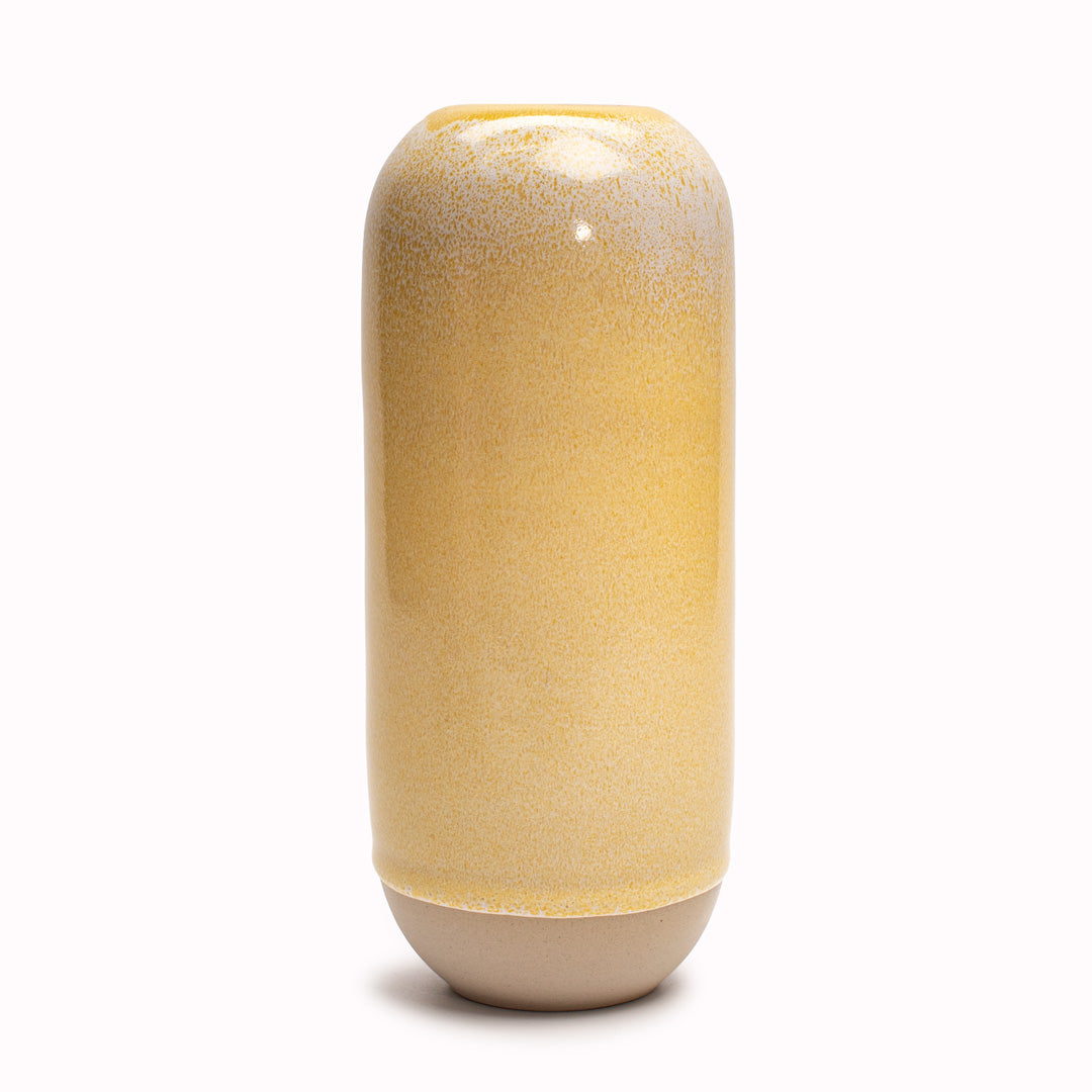 The Cream hued Moneypenny design is hand-thrown in watertight stoneware and due to the rounded taper at the top of the vase, the glaze melts down the sides of the cylindrical vase mimicking melting ice.