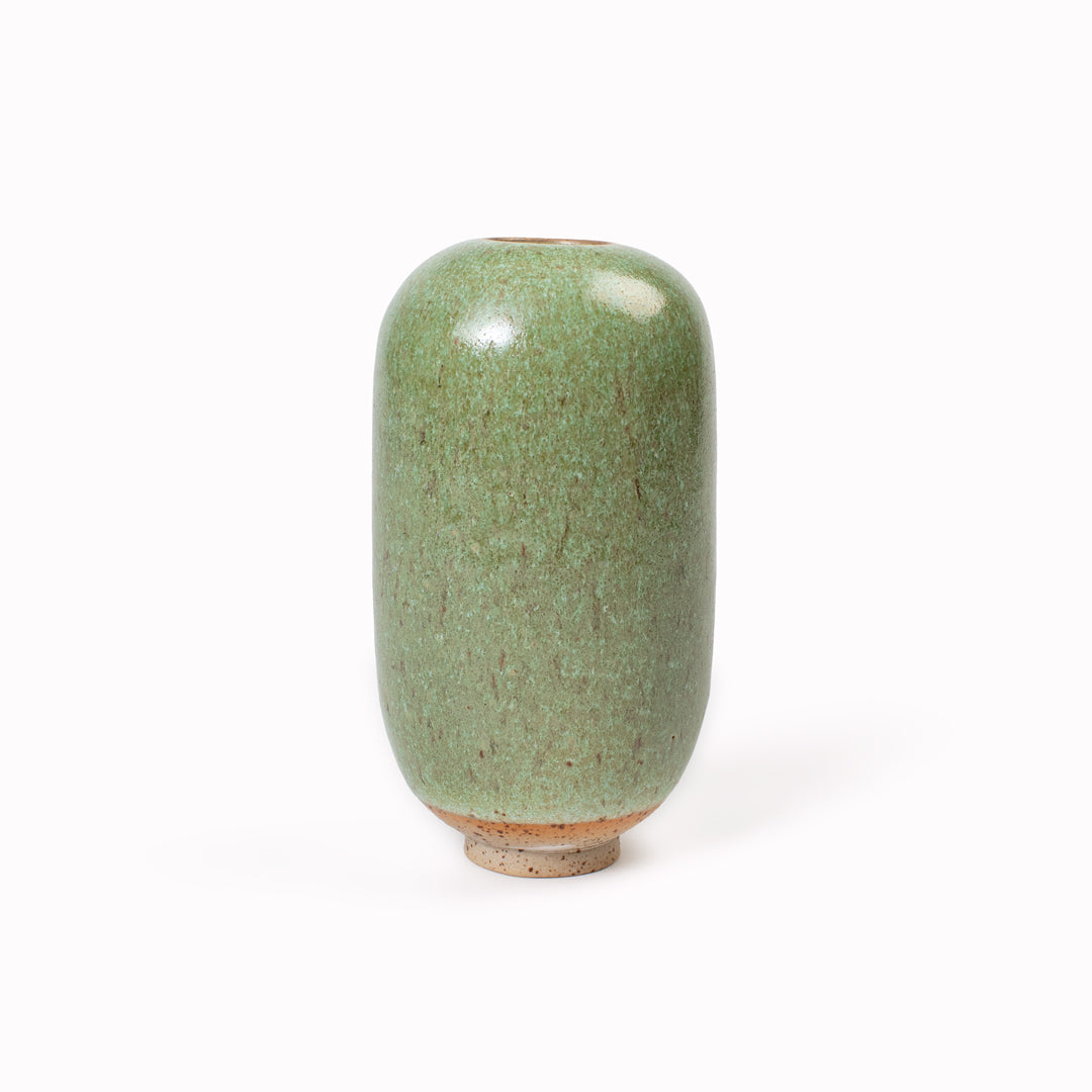 The Mountain Moss Mini Yuki Vase design is hand-thrown in watertight stoneware. Due to the rounded taper at the top of the vase, the glaze melts down the sides of the cylindrical vase mimicking melting ice.&nbsp;