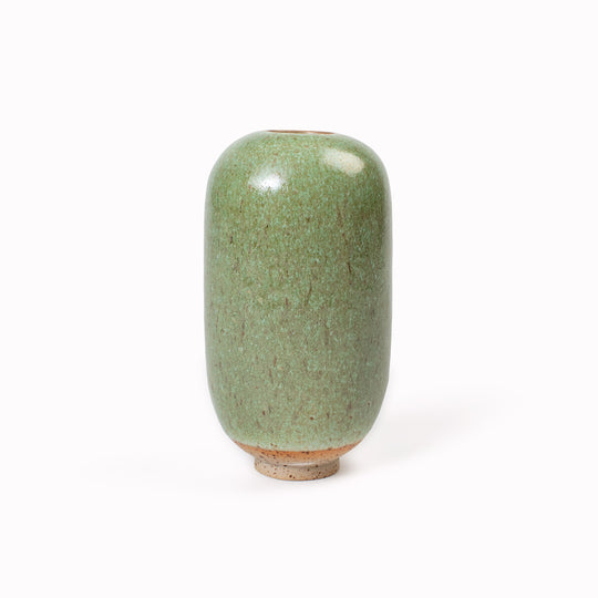 The Mountain Moss Mini Yuki Vase design is hand-thrown in watertight stoneware. Due to the rounded taper at the top of the vase, the glaze melts down the sides of the cylindrical vase mimicking melting ice.&nbsp;