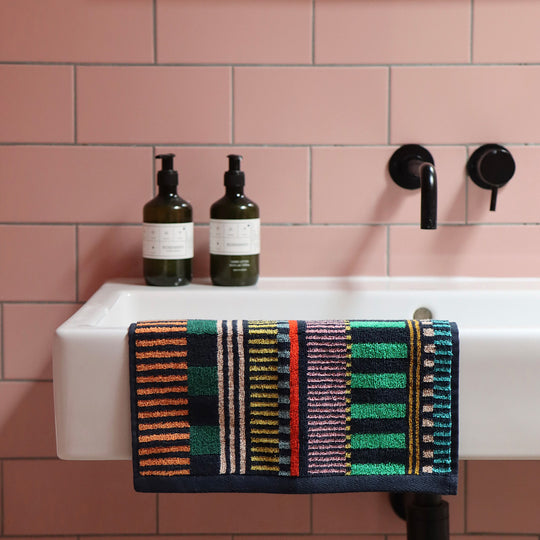 The Multi Stripe Collection of Towels from Donna Wilson are a kaleidoscope of colour and have a retro vibe that we love! The Face Cloth is 30 x 30cm and will add a splash of bold colour to the bathroom. seen on sink.