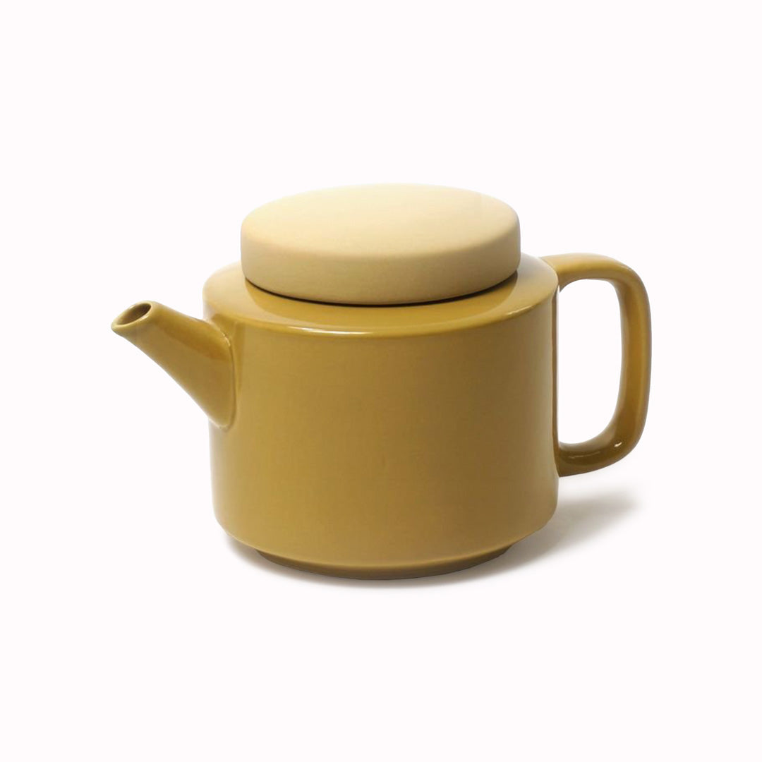 Large stoneware teapot from Dutch company Kinta who produce contemporary ceramics and homeware. The large teapot is mustard yellow, with a gloss glaze exterior body finish and matt glaze lid. Its design is influenced  by ceramic trends of the 1960s, but with a pleasing modern and neutral colour palette.