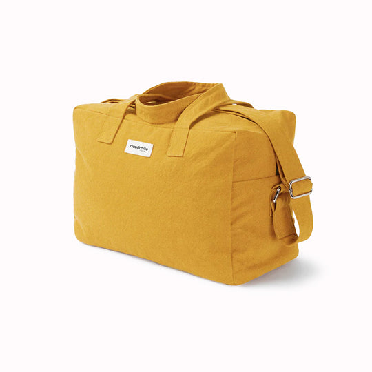 Mustard Sauval bag from Parisian brand Rive Droite is a compact everyday messenger bag made from recycled cotton. Viewed from an angle