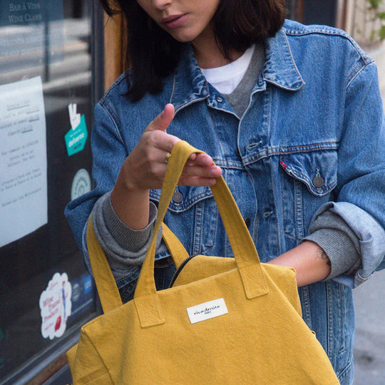 Mustard Sauval bag from Parisian brand Rive Droite is a compact everyday messenger bag made from recycled cotton. lifestyle image
