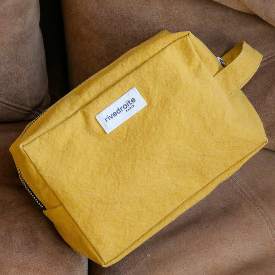 Mustard Tournelles XL. A zippered pouch in a pleasing cube shape which is large enough for essential make up items on a weekend away. Lifestyle image