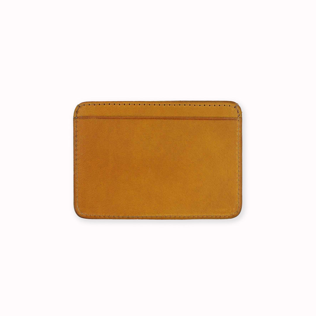 A slim and stylish cardholder from Escuyer, in Mustard yellow leather. The cardholder is handmade by Portuguese artisans, using vegetable-tanned leather from a tannery in Tuscany, Italy.