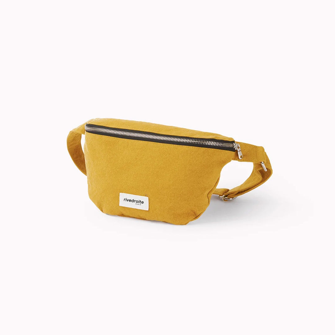The Mustard Custine Belt Bag is a stylish and practical accessory crafted from upcycled denim. Designed by Rive Droite