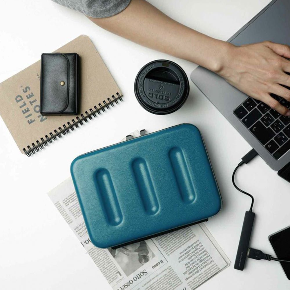 Nahe Hard-Shell Case by Japanese stationery brand Hightide Penco. On table with laptop