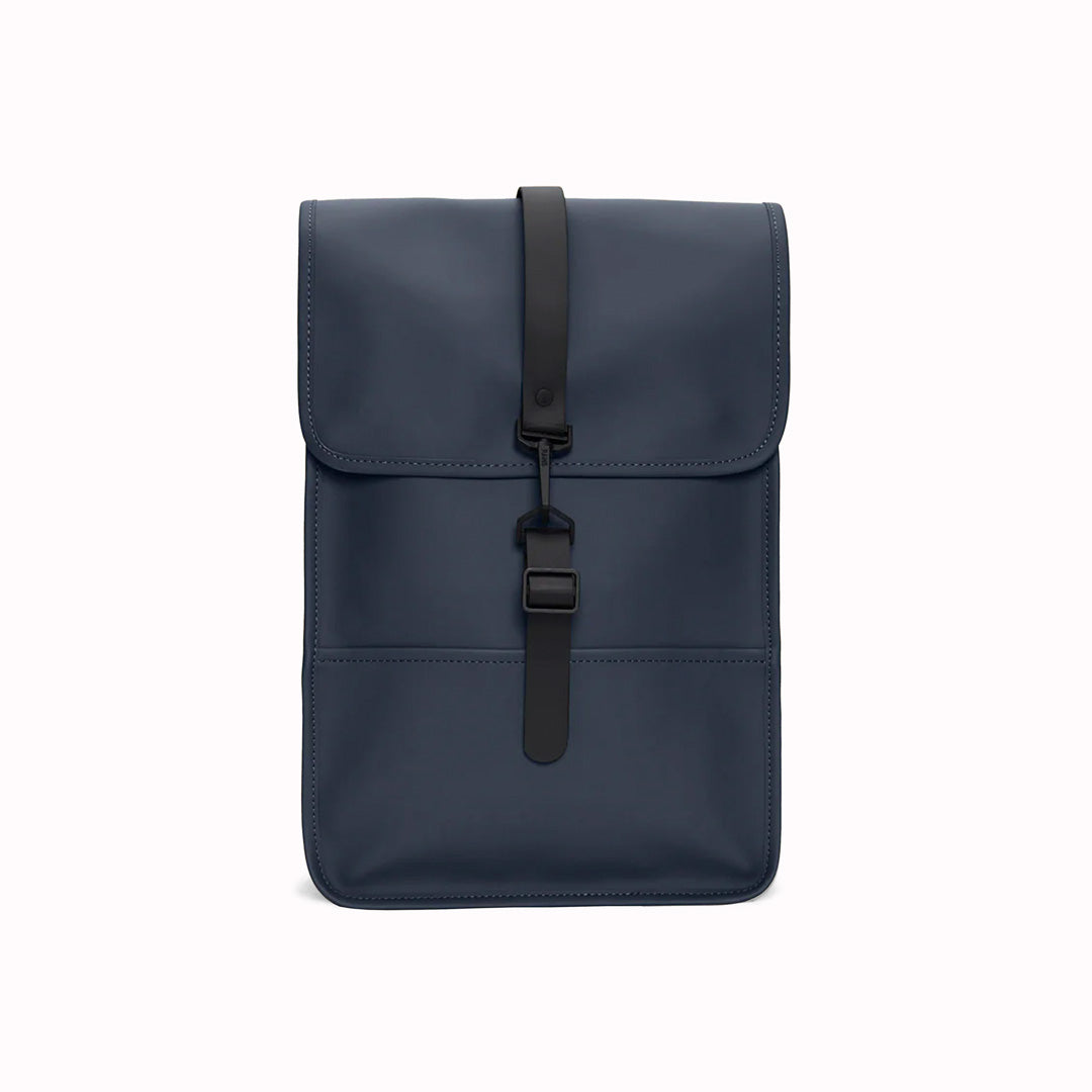 Navy Mini backpack - Made from Rains' signature water-resistant fabric with a matte finish, this minimalistic, modern rucksack is called 'Mini' but is the perfect size for daily use. It has an inside laptop pocket, a spacious main compartment and a hidden phone pocket on the backside.