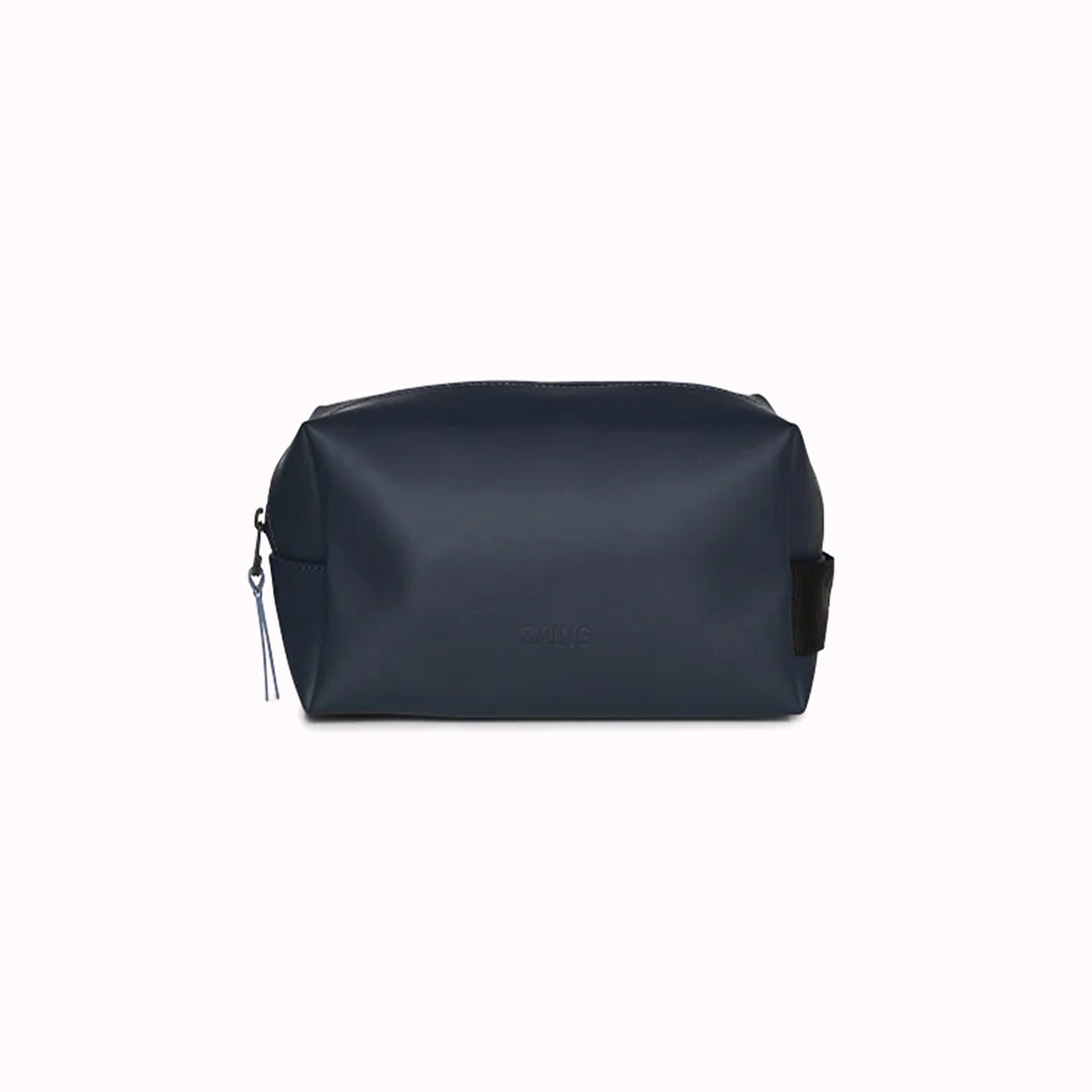 The navy blue small unisex wash bag by Rains features one main compartment with inside sleeve pockets and is large enough to fit one’s essential toiletries. Made from a smooth, waterproof fabric it also has a webbing grab handle and a water-repellent zipper.