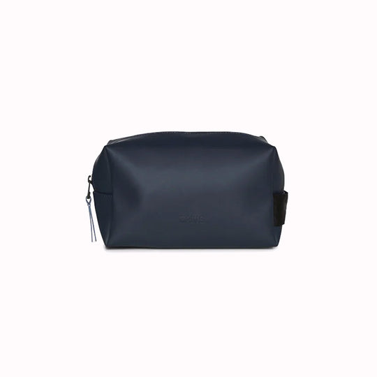 The navy blue small unisex wash bag by Rains features one main compartment with inside sleeve pockets and is large enough to fit one’s essential toiletries. Made from a smooth, waterproof fabric it also has a webbing grab handle and a water-repellent zipper.