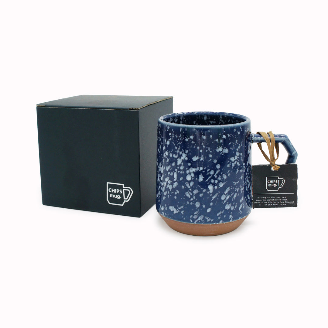 Compact and Easy to hold and stackable for easy storage. This Splash mug has a white glaze playfully sprayed over deep navy with an unglazed base. They are sturdy and comfortable to hold with a unique silhouette. - with box