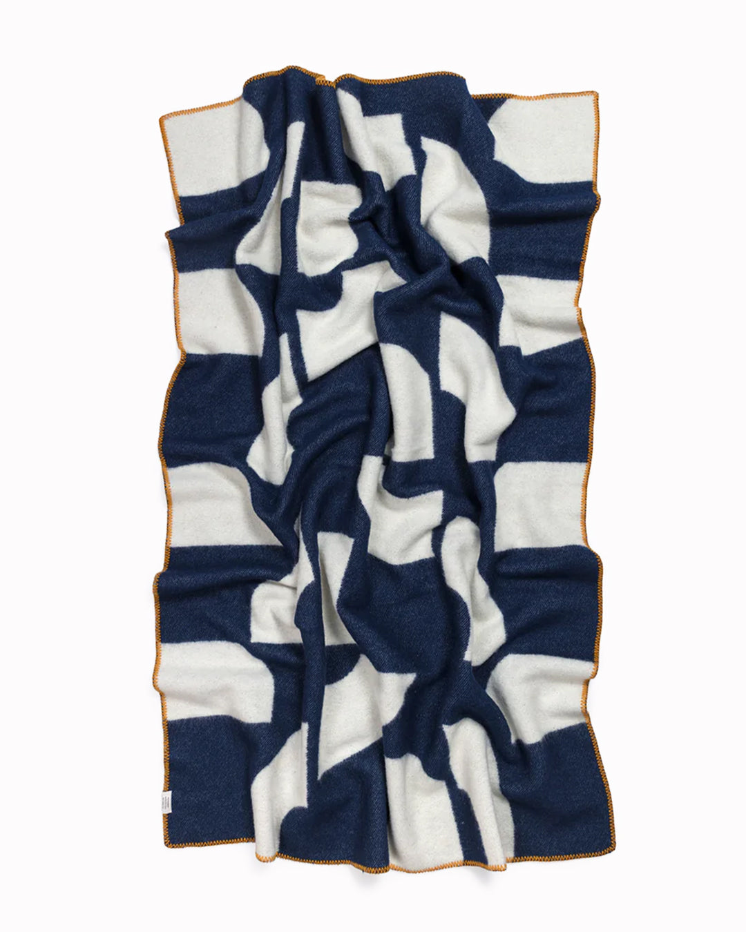 A modern throw in with graphic pattern in navy and ivory that sits somewhere between functional and decorative