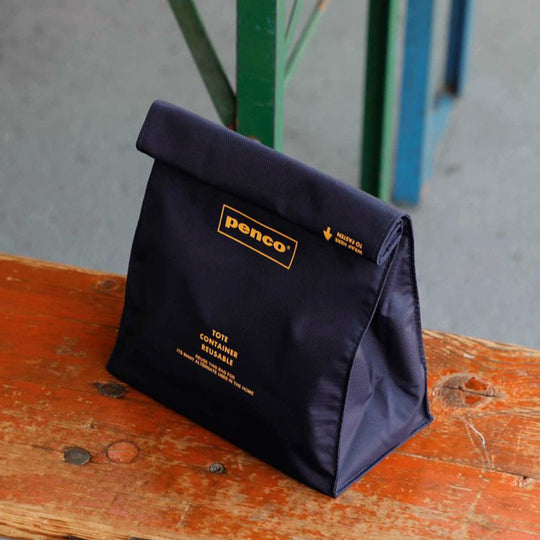 Navy Roll Top Pouch from Penco, offers a convenient seal by rolling up the top similar to a paper bag.