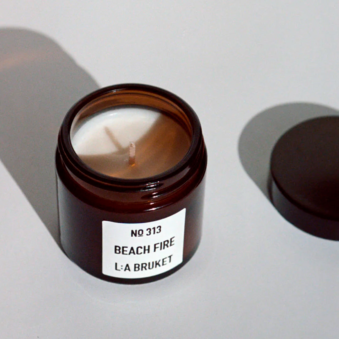 The L:A Bruket 2025 Nightfall Winter Gift Kit contains a soothing duo to wind down the day and prepare for a good night of sleep: 313 Candle Beach Fire 50g and 311 Goodnight Orange Blossom Lip Balm 14g