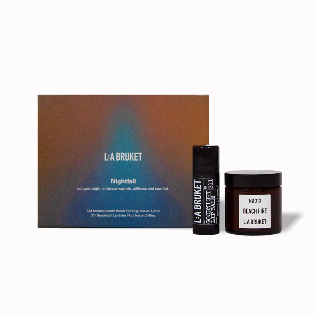 The L:A Bruket 2025 Nightfall Winter Gift Kit contains a soothing duo to wind down the day and prepare for a good night of sleep: 313 Candle Beach Fire 50g and 311 Goodnight Orange Blossom Lip Balm 14g
