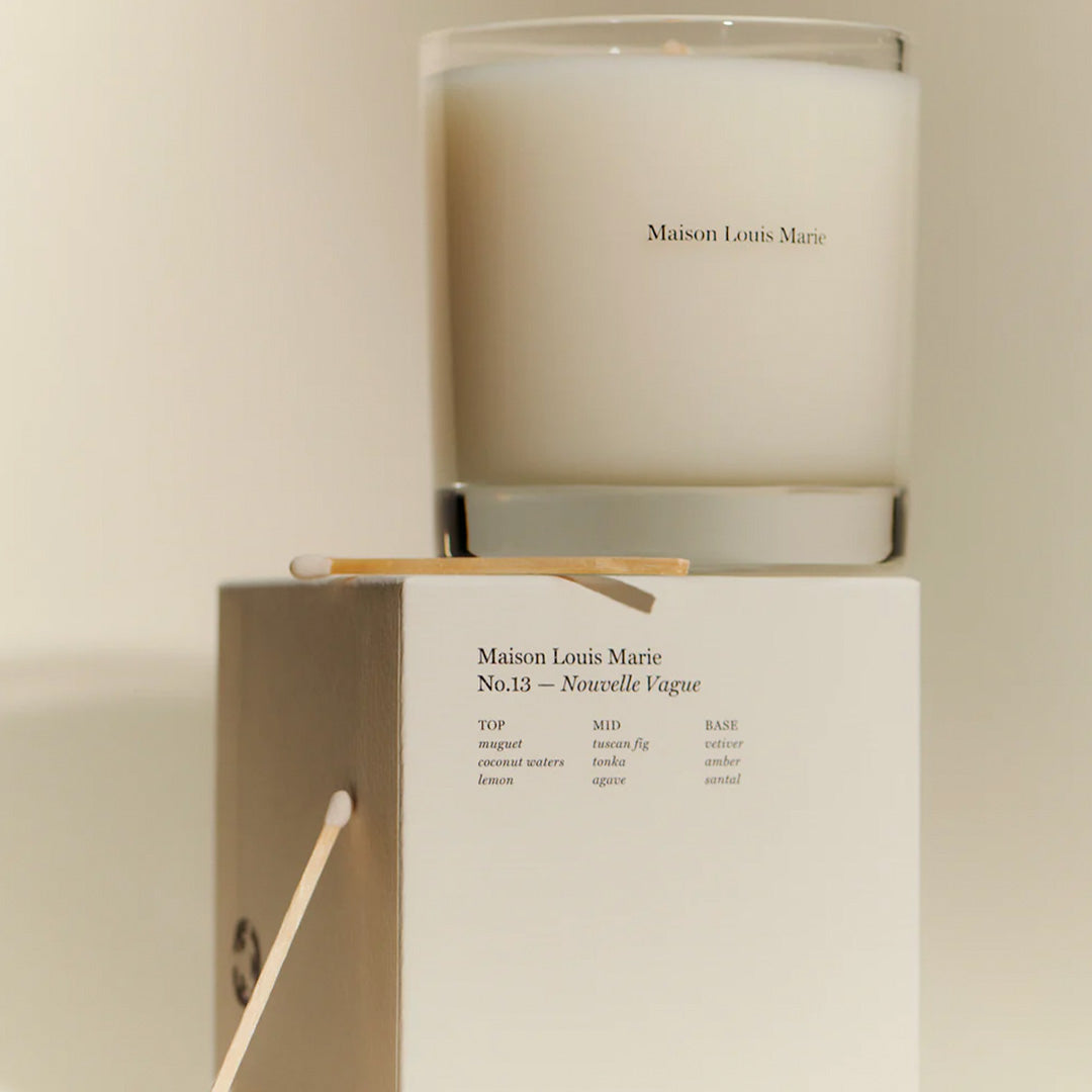 Nouvelle Vague No13 Candle with box. Oceanside streets on the  idyllic Italian island of Capri on the Amalfi coast is the inspiration behind this perfume oil. Lily of the Valley, Tuscan Fig and Tonka Bean are the standout notes with the fragrance having uplifting citrus and floral notes with an earthy tonka undertone to keep it grounded.