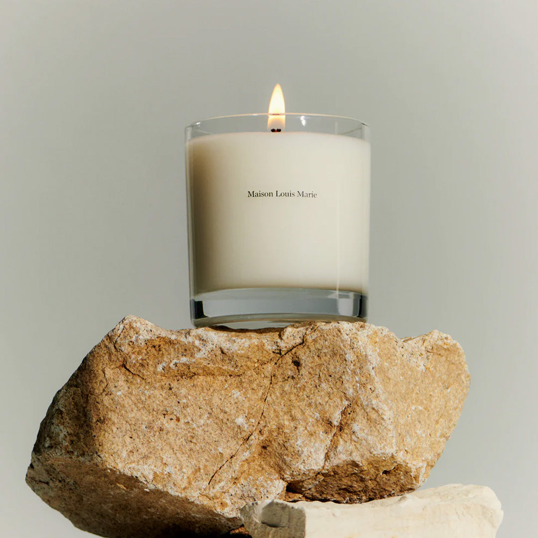 Nouvelle Vague No13 Candle on a rock. Oceanside streets on the  idyllic Italian island of Capri on the Amalfi coast is the inspiration behind this perfume oil. Lily of the Valley, Tuscan Fig and Tonka Bean are the standout notes with the fragrance having uplifting citrus and floral notes with an earthy tonka undertone to keep it grounded.