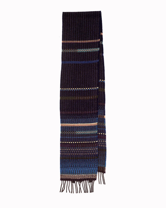 The Noah scarf features a subtle textured weave of background colour offset by intricate detailing at the borders, where delicate floral motifs and patterns mingle with bold cross-hatches, contrasting pinstripes, and graphic bands.&nbsp;