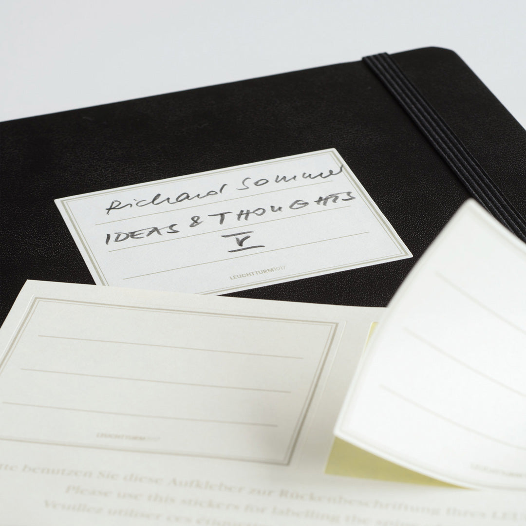 The B6+ Softcover Dotted Notebook features 2 page markers, a blank table of contents, numbered pages, a gusseted pocket for loose notes and business cards, an elastic enclosure band
