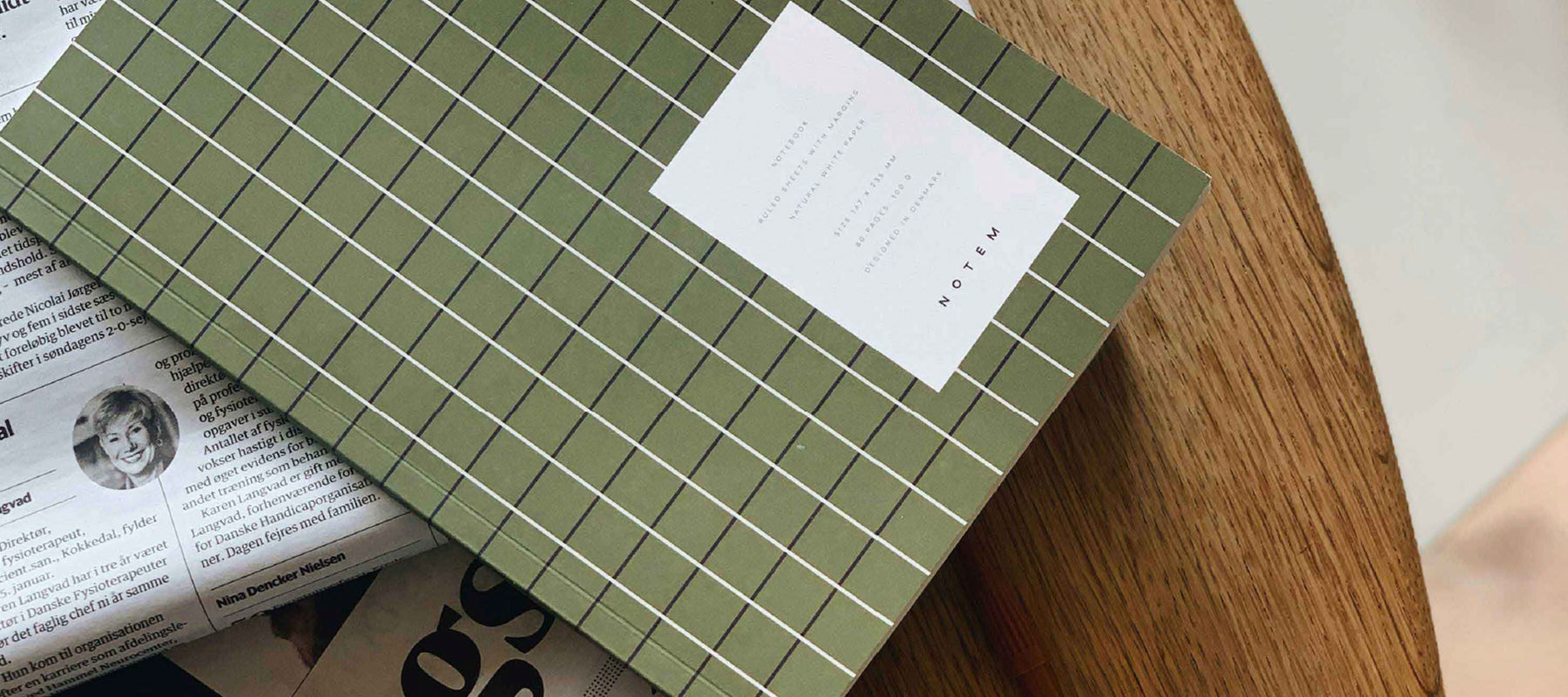 Notem Stationery, Danish Stationery brand. Green Grid notebook on coffee table